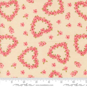 a fabric with a floral pattern of hearts and flowers on a light beige background.