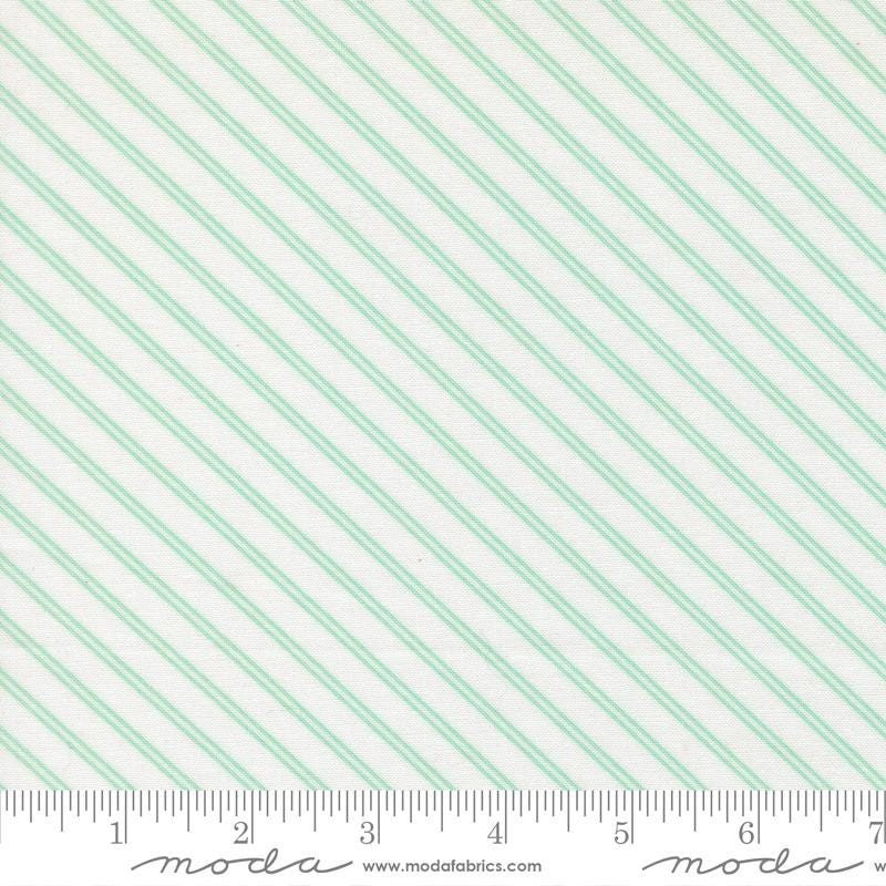 The image is a fabric with a diagonal striped pattern in shades of green and white.