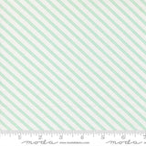 The image is a fabric with a diagonal striped pattern in shades of green and white.