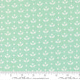 a repeating pattern of white flowers on a light green background.