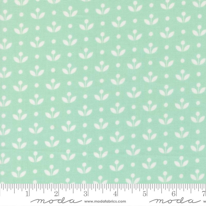 a repeating pattern of white flowers on a light green background.
