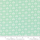 a repeating pattern of white flowers on a light green background.