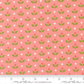 a repeating pattern of green leaves and red flowers on a pink background, with white polka dots scattered throughout.
