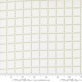 The image is a close-up of a fabric with a grid pattern of small green dots arranged in a grid-like design.