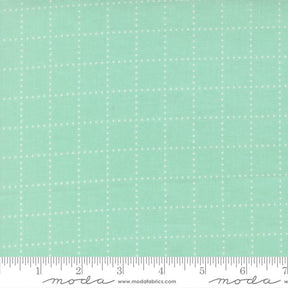 The image is a fabric with a grid pattern of small white dots or stars, creating a mint green or light green color.