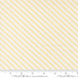 a fabric with diagonal yellow stripes arranged in a repeating pattern. The fabric is white and has a ruler placed at the bottom to indicate its size.