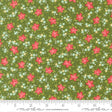 The image is a fabric with a floral pattern of red flowers and green leaves. The pattern is repeated across the fabric, creating a visually appealing and colorful design.
