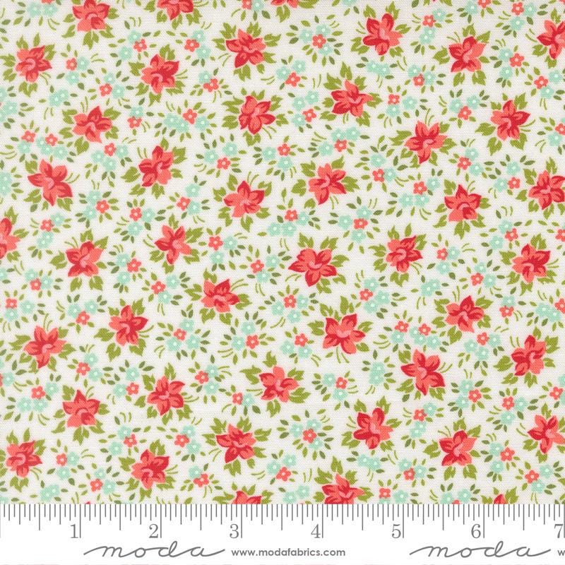 The image is a fabric with a floral pattern, featuring red flowers and green leaves. The fabric appears to be a light-colored material, possibly white or cream, with a repeating pattern of red flowers and green leaves. The image does not contain any text or additional objects, and the focus is on the floral pattern.