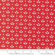 a red fabric with a repeating pattern of white flowers and dots. The pattern is evenly spaced and creates a visually appealing design.