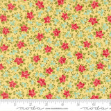The image is a close-up of a fabric with a floral pattern, featuring small red flowers and green leaves on a yellow background.