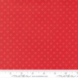 The image is a close-up of a red fabric with white polka dots, and there is a ruler for scale at the bottom of the image.