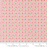 The image is a fabric with a pink and green checkered pattern, featuring small flower-like designs in shades of green and red.