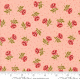 a fabric with a repeating pattern of red roses and green leaves against a light pink background.
