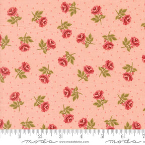 a fabric with a repeating pattern of red roses and green leaves against a light pink background.