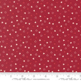 a red fabric with white hearts scattered across it.