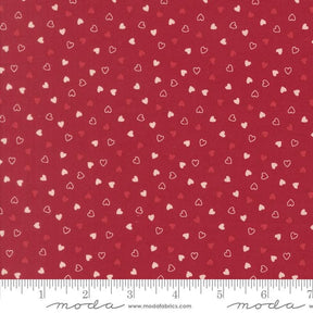 a red fabric with white hearts scattered across it.