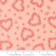 a fabric with a repeating pattern of pink hearts and flowers on a peach background.