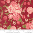 a close-up view of a vibrant red fabric adorned with a floral pattern. The pattern consists of various pink and red flowers, including roses, hydrangeas, and tulips, interspersed with green leaves. The fabric appears to be a textile or fabric material, with a ruler visible in the bottom right corner for scale.