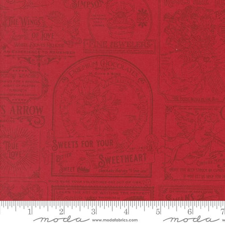 a red fabric with various decorative text and illustrations, including phrases like "The Wings of Love", "The Arrow", "True Love", "Sweetheart", and "Sugar". The text and illustrations are arranged in a repeating pattern, creating a visually appealing and decorative design.