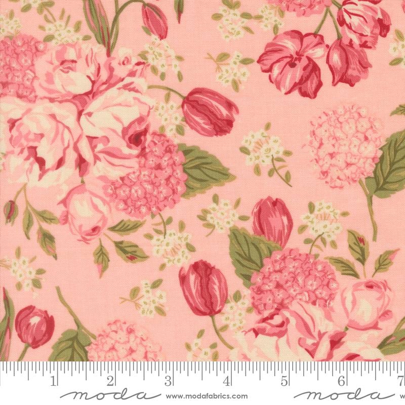 a close-up view of a fabric with a floral pattern in shades of pink and green. The pattern includes various types of flowers, such as roses, hydrangeas, and tulips, as well as leaves and stems. The fabric appears to be a soft, pastel-colored material, suitable for clothing or home decor.