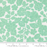 a repeating pattern of green floral designs on a white background.
