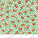 The image is a fabric with a floral pattern in shades of green and red. The pattern consists of small red flowers scattered across the fabric, creating a visually appealing and vibrant design.