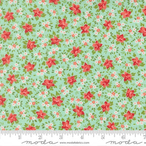 The image is a fabric with a floral pattern in shades of green and red. The pattern consists of small red flowers scattered across the fabric, creating a visually appealing and vibrant design.