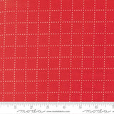 The image is a close-up of a red fabric with a grid pattern of small white dots.