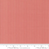 The image is a close-up of a red and white striped fabric, with a ruler for scale at the bottom.
