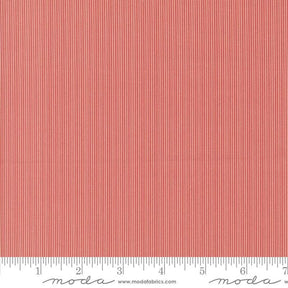 The image is a close-up of a red and white striped fabric, with a ruler for scale at the bottom.