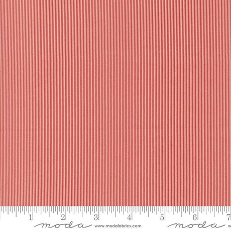 The image is a close-up of a red and white striped fabric, with a ruler for scale at the bottom.