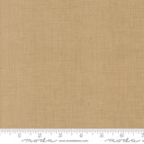 The image is a close-up of a fabric with a light brown or beige color. There is a ruler at the bottom of the image, indicating the size of the fabric in inches.