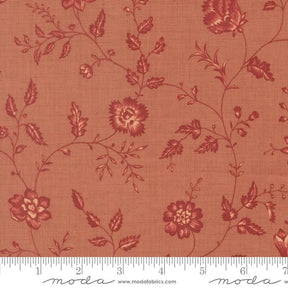 a fabric with a floral pattern in shades of red and orange. The pattern consists of various flowers and leaves, creating a visually appealing and intricate design. The fabric appears to be made of a soft, textured material, suitable for clothing or home decor.