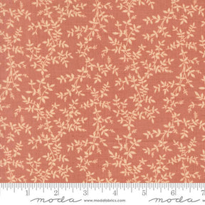 a fabric with a repeating pattern of leaves and branches in shades of orange and beige. The pattern is printed on the fabric, creating a visually appealing and textured design.