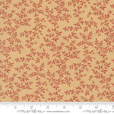 a fabric with a repeating pattern of red leaves and branches on a beige background.