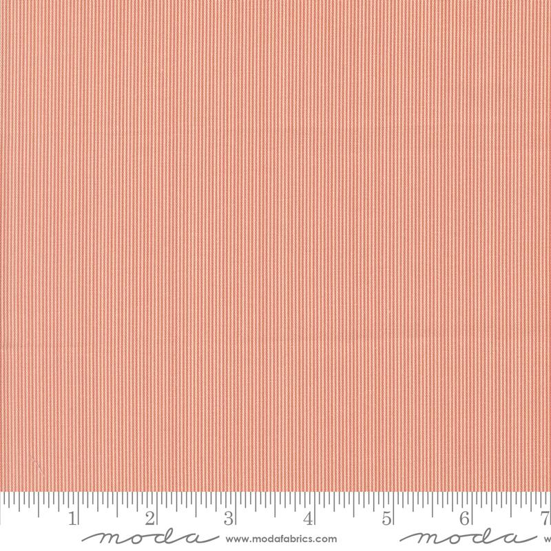 The image is a close-up of a fabric with a striped pattern in shades of orange and red.