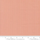 The image is a close-up of a fabric with a striped pattern in shades of orange and red.