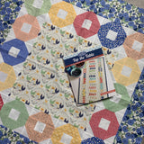 Put a Ring on It Topper Kit uses Break of Day fabric by Sweet Fire Road for Moda fabrics. This topper is 42&quot; x 42&quot; Includes Book